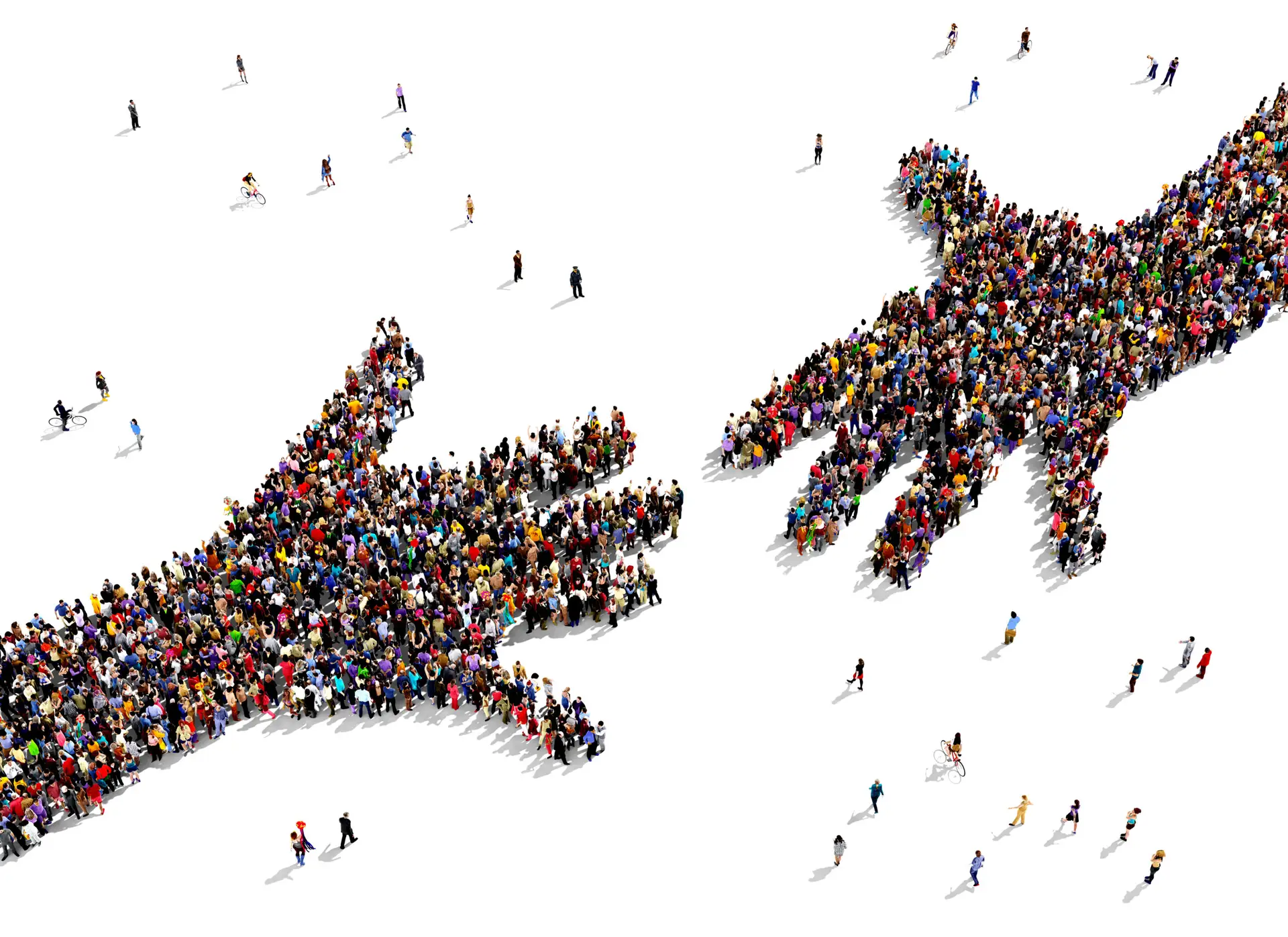 aerial photo of people forming image of two hands reaching to shake
