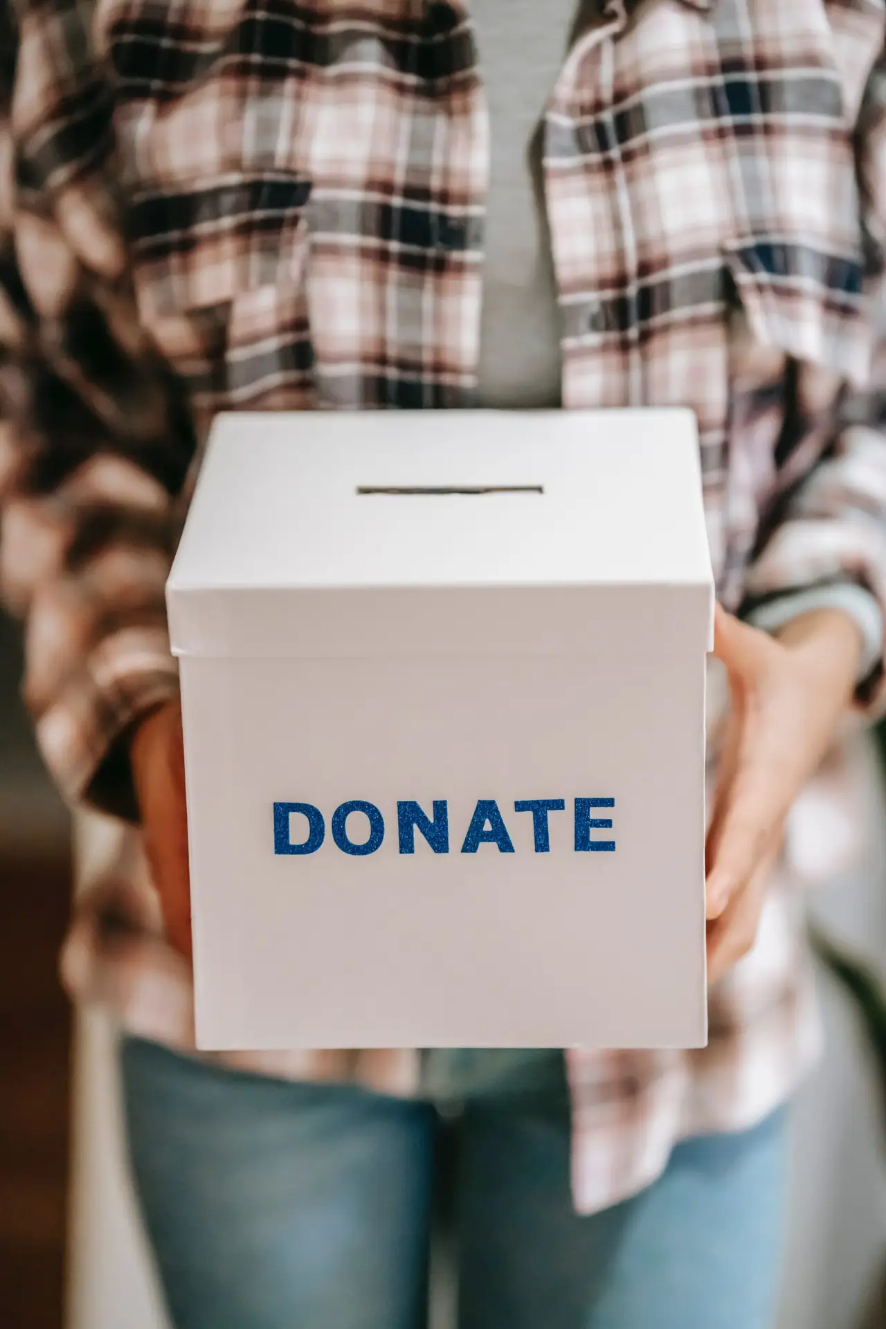 person holding donation box for not-for-profit organization