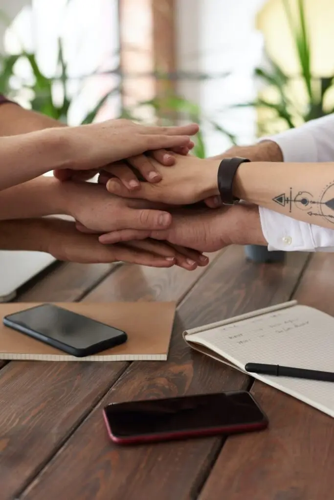 teamwork shown with stacked hands over table