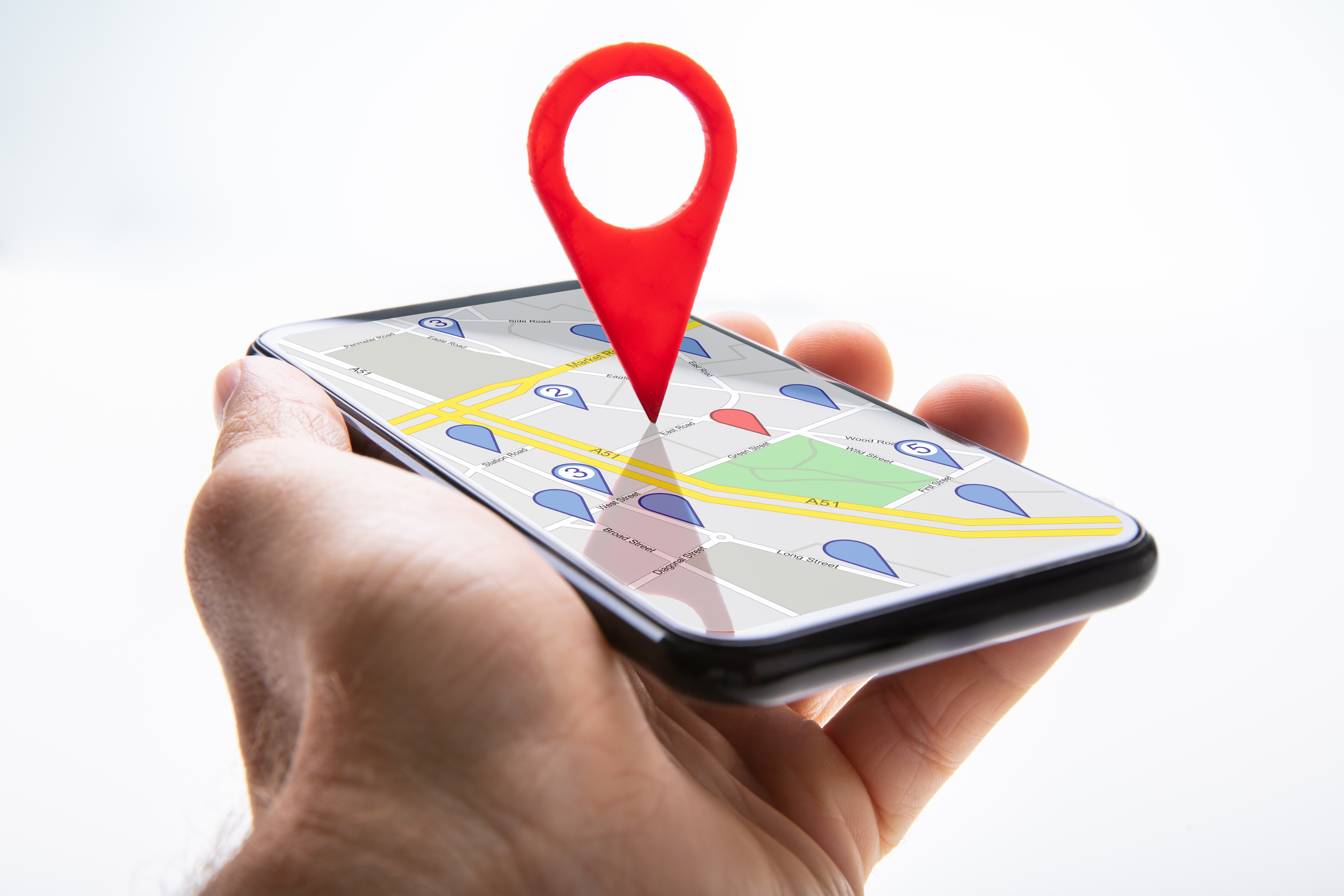 graphic of a location pin extending out of a phone screen's map