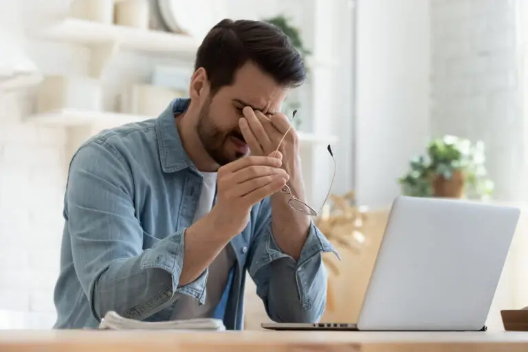 photo of an upset worker at his desk