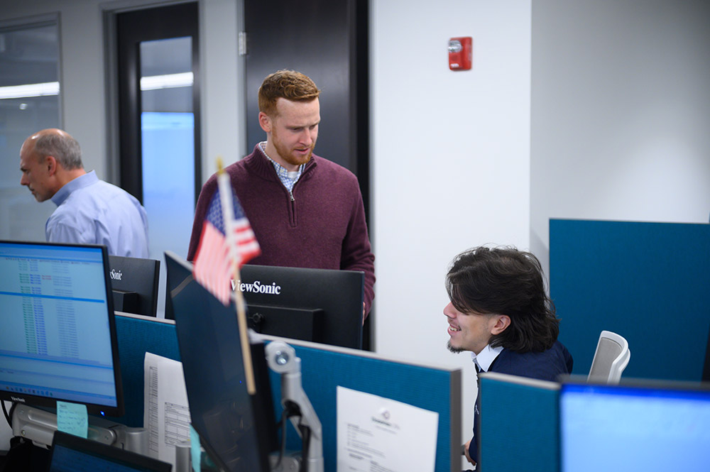 Employees collaborating at desks