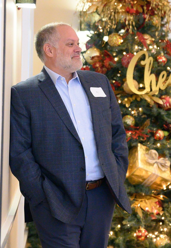 Rex Miller poses by Christmas tree